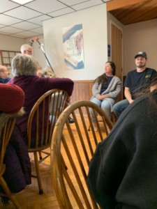 Pastor Bob preparing to "knight" (bless/pray over) Joel and Danielle.