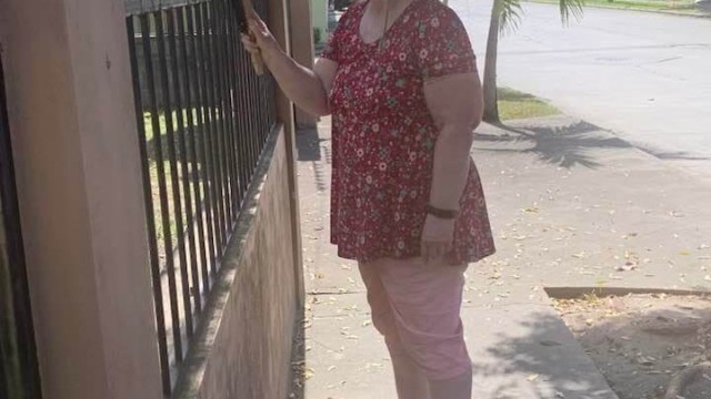 Sanding and repainting the iron security fence around the church.