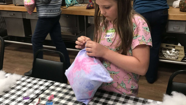 Parker working on sewing her pillow