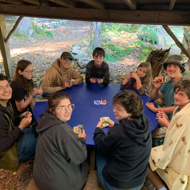 Nine of us playing a giant game of uno.