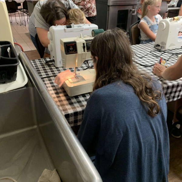 Kylie sewing at co-op