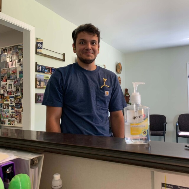 Grace and Emi put a bendy giraffe in David's pocket. He's unsure of how to react.