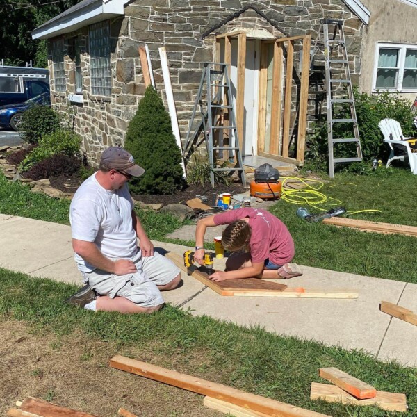 Two members of the work group working on the mud room/entryway to Hannah's house