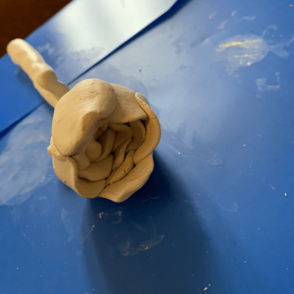 Jett's clay flower. He was making layers of-the rose by pressing the clay flat and going into a circle. LOVE the detail
