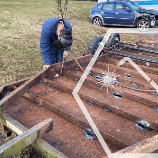 Kai working on welding a trailer