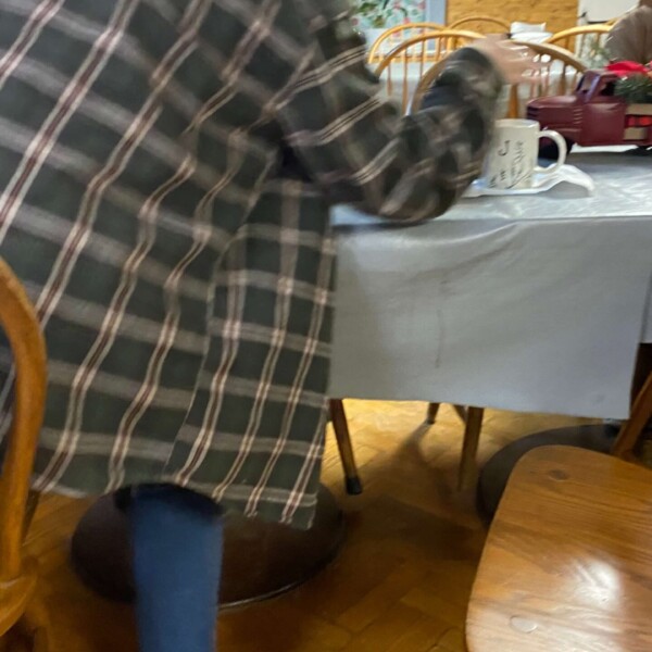 Grace putting something in Justin's coffee