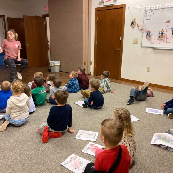 Miss Karlie reading a story to our Pre-K class at KFJ