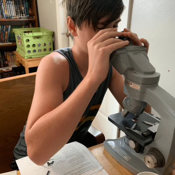 Peyton learning how to use a microsope